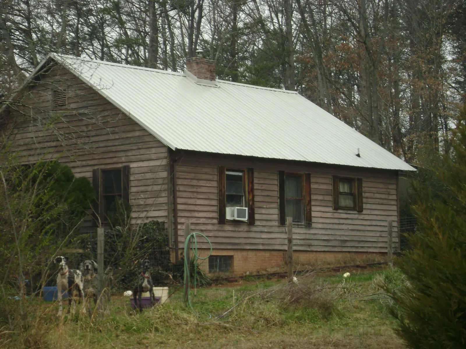 White metal roof on an old wood sided farmhouse, from a Metal Roof Installation job in Waleska